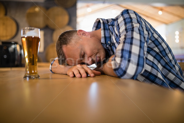 Drunken man sleeping on bar counter Stock photo © wavebreak_media