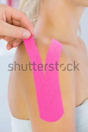 Young woman with Breast Cancer Awareness ribbon checking lumps while touching breast Stock photo © wavebreak_media