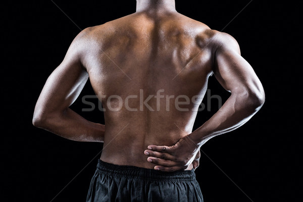 Mid section of muscular athlete suffering through back pain Stock photo © wavebreak_media