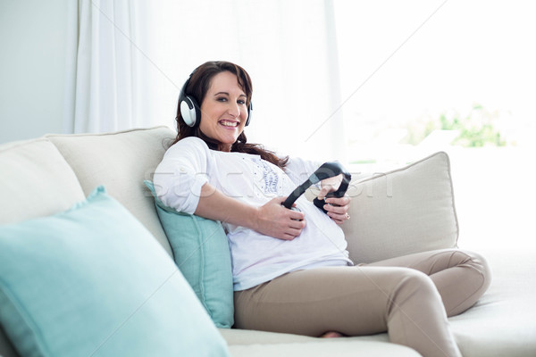 Foto stock: Mujer · embarazada · auriculares · vientre · salón · mujer