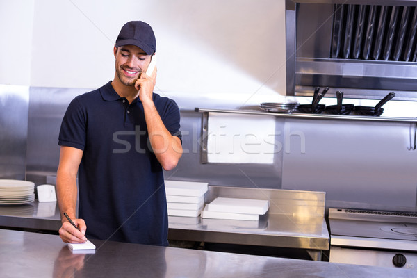 Pizza delivery man taking an order over the phone Stock photo © wavebreak_media