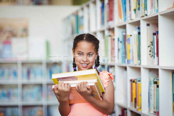 Lächelnd Mädchen halten Pfund Bibliothek glücklich Stock foto © wavebreak_media