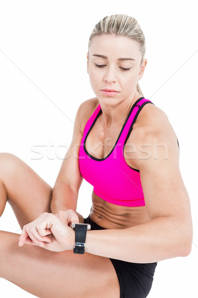 Kobiet sportowiec posiedzenia smart oglądać biały Zdjęcia stock © wavebreak_media