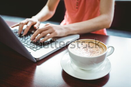 Student using laptop while having coffee Stock photo © wavebreak_media