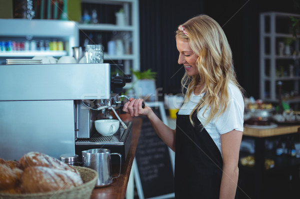 Smiling waitress making cup of coffee Stock photo © wavebreak_media
