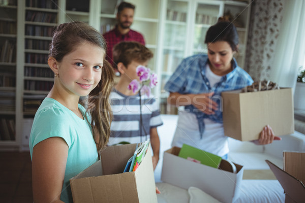 Stock photo: Family unpacking cartons together