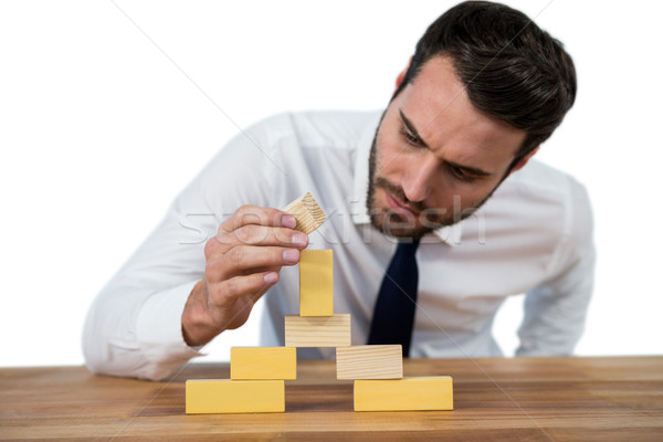 Businessman placing wooden block on a tower Stock photo © wavebreak_media