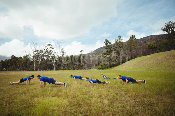 Fit people performing pushup exercise Stock photo © wavebreak_media