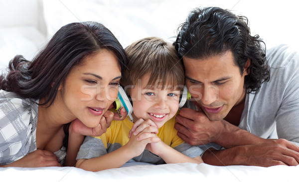 Joyful parents listening to music with their son Stock photo © wavebreak_media