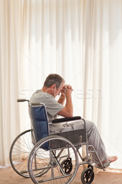 Thoughtful man in his wheelchair at home Stock photo © wavebreak_media
