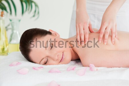 Smilling young woman having masssage oil versed on her back in a spa Stock photo © wavebreak_media