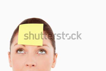 Cute woman with a sign on her forehead against a white background Stock photo © wavebreak_media
