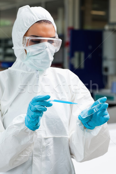 Portrait of a protected science student dropping blue liquid in a Petri dish in a laboratory Stock photo © wavebreak_media