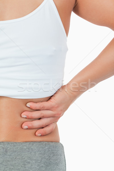 Close up of female with back pain against a white background Stock photo © wavebreak_media
