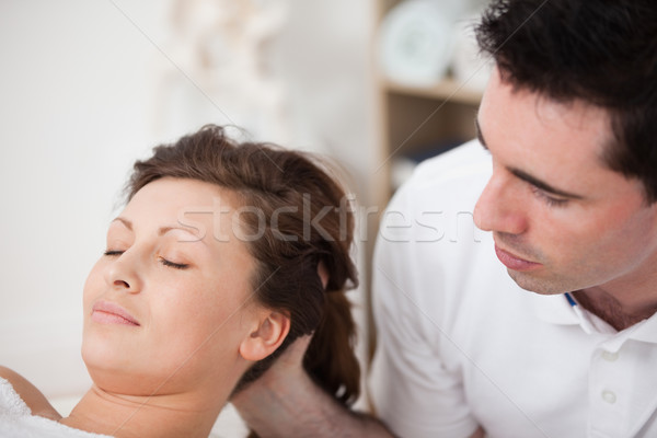 A doctor massaging the head of his patient while holding it in a room Stock photo © wavebreak_media