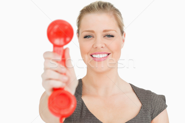 Retro phone red in a hand of a pretty woman against white background Stock photo © wavebreak_media