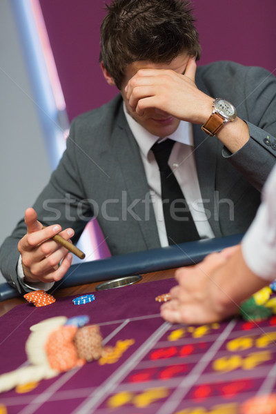 Hombre sesión mesa casino cigarro Foto stock © wavebreak_media