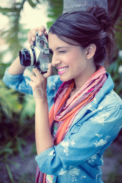 Cheerful brunette taking a photo outside  Stock photo © wavebreak_media