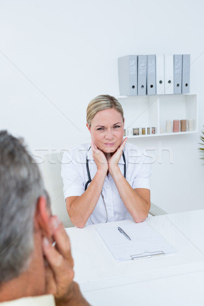 Doctor examining patient with neck ache Stock photo © wavebreak_media