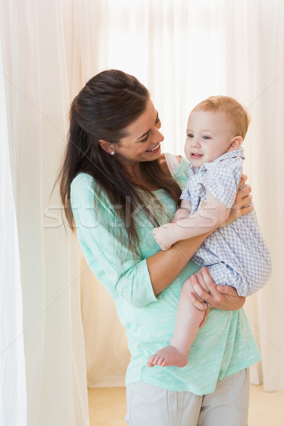 Happy mother holding baby boy Stock photo © wavebreak_media