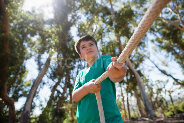 Boy practicing tug of war during obstacle course training Stock photo © wavebreak_media