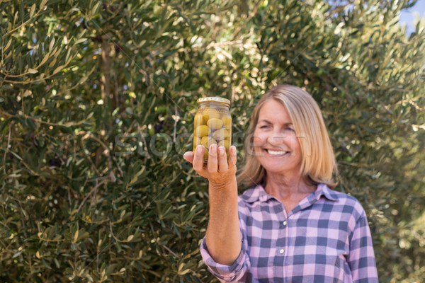 Happy woman examining pickled olive in farm Stock photo © wavebreak_media