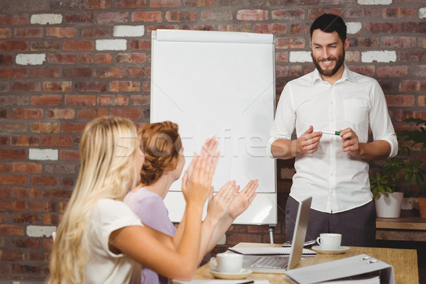 Stock photo: Women praising male colleague during presentation 