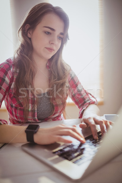 Stock photo: Serious hipster businesswoman working on computer