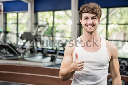 Muscular man posing with thumbs up Stock photo © wavebreak_media