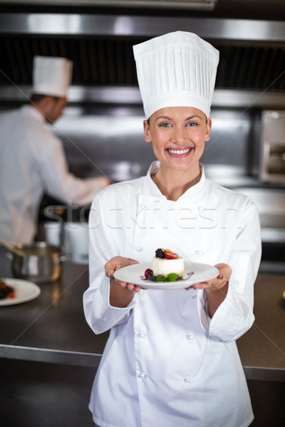 Portrait of smiling female chef holding plate in kitchen Stock photo © wavebreak_media