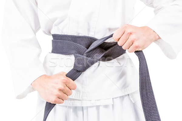 Fighter tightening karate belt Stock photo © wavebreak_media