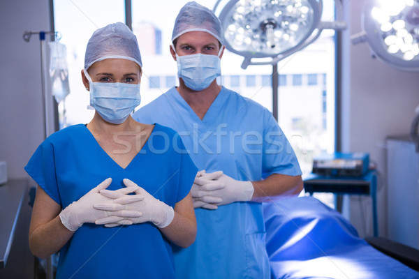 Portrait of male and female nurse wearing surgical mask in operation theater Stock photo © wavebreak_media
