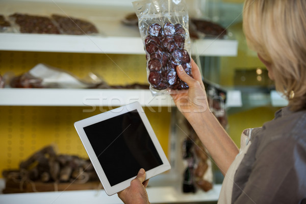 Female staff maintain records of meat on digital tablet at counter Stock photo © wavebreak_media