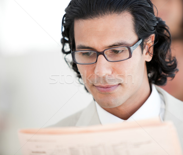 Confident businessman reading a newspaper Stock photo © wavebreak_media