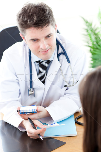 Confident male doctor giving pills to a paient in a practice Stock photo © wavebreak_media