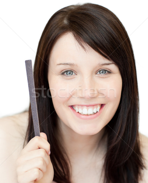 Portrait of an animated young woman holding a nail file against white background Stock photo © wavebreak_media