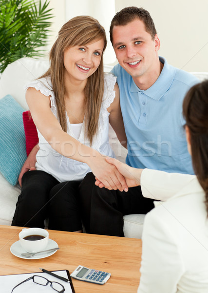 Attractive couple concluding a car contract with a female dealer in the living-room Stock photo © wavebreak_media