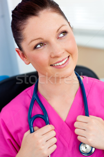 Stock photo: Pensive female surgeon with a stethoscope in her office