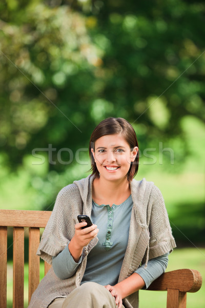 Woman phoning on the bench Stock photo © wavebreak_media