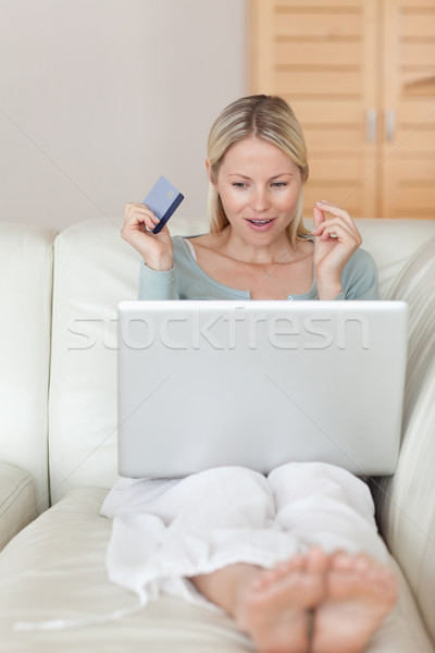 Young woman on the sofa about to win an online auction Stock photo © wavebreak_media