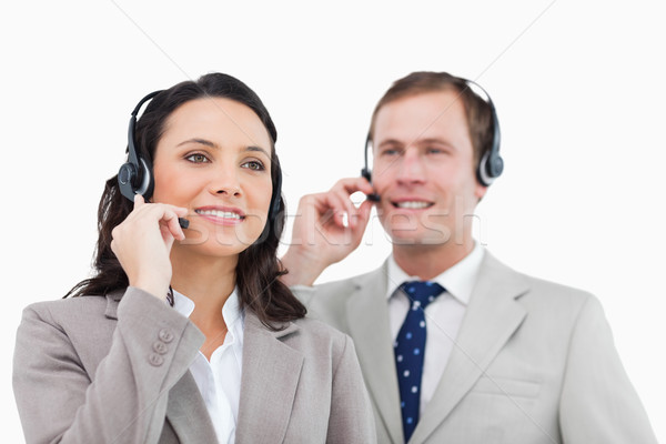 Stock photo: Telephone help desk employees with headsets against a white background