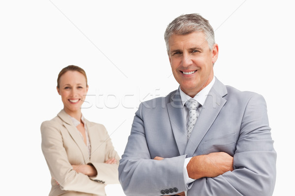 Smiling business people with folded arms against white background Stock photo © wavebreak_media