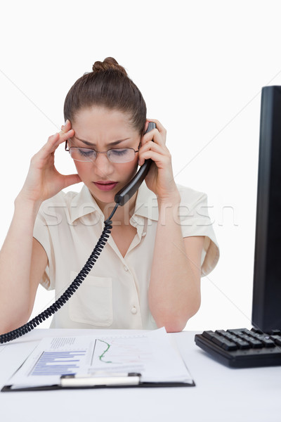 Portrait of a sad manager making a phone call while looking at statistics against a white background Stock photo © wavebreak_media