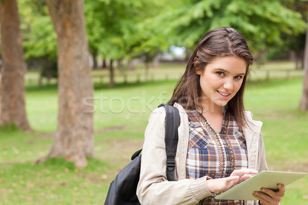 Portrait of a first-year female student using a touch pad in a park Stock photo © wavebreak_media