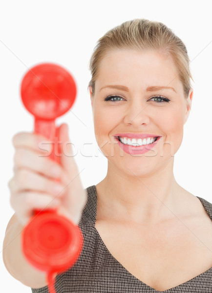 Woman smiling showing a retro phone against white background Stock photo © wavebreak_media