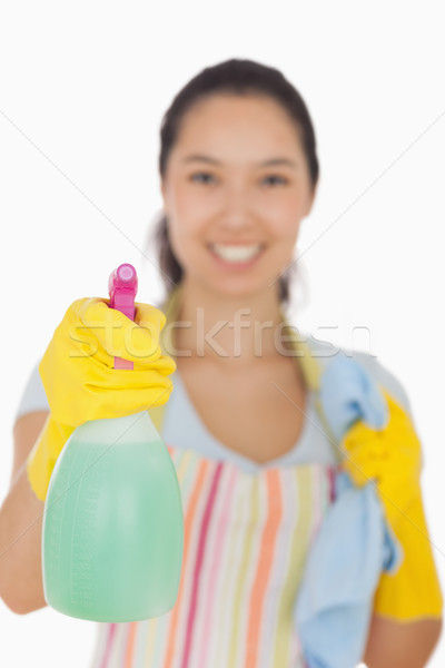 Smiling woman in apron and gloves holding spray bottle and cloth Stock photo © wavebreak_media