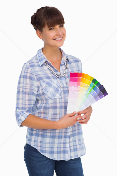 Pretty woman with fringe holding colour charts Stock photo © wavebreak_media