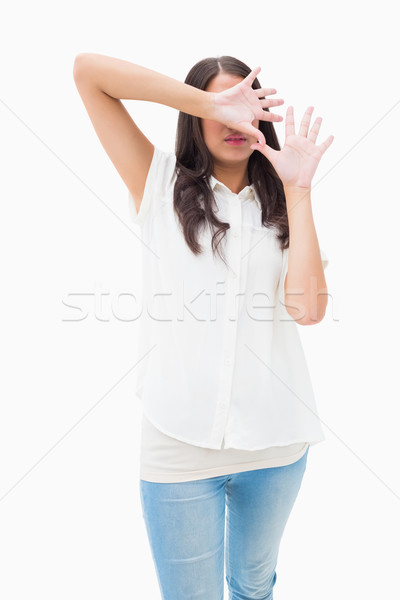 Fearful brunette covering her face Stock photo © wavebreak_media
