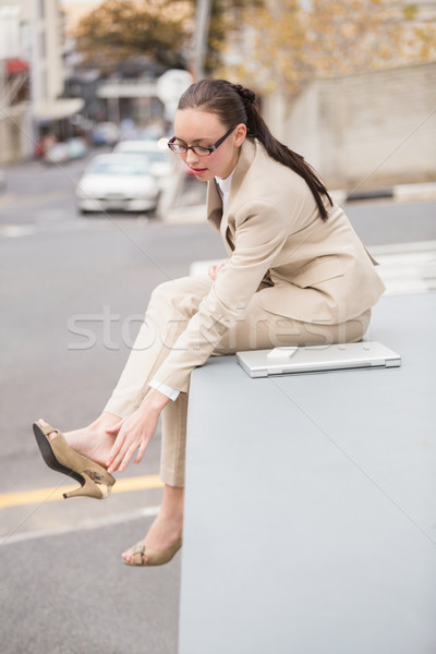 Young businesswoman adjusting her shoe Stock photo © wavebreak_media