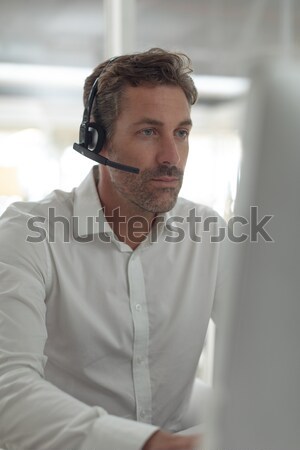 Serious businessman with hand on chin holding marker Stock photo © wavebreak_media